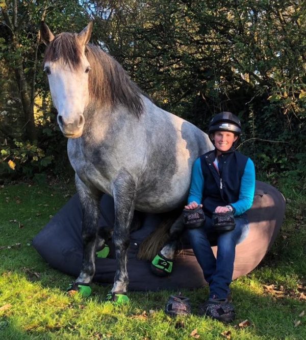 Emma Massingale and her horse sitting down in Cavallo Green Trek Horse Hoof Boots