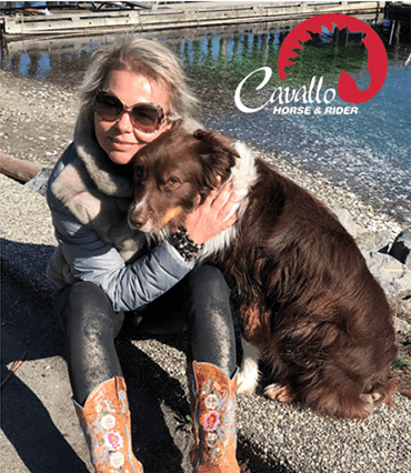 Cavallo Horse & Rider gear showcased by woman and dog by the water, highlighting equine care and outdoor lifestyle.
