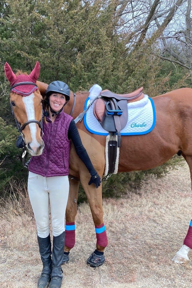 Rider with horse wearing Cavallo hoof boots, showcasing equine gear for optimal horse care and performance.